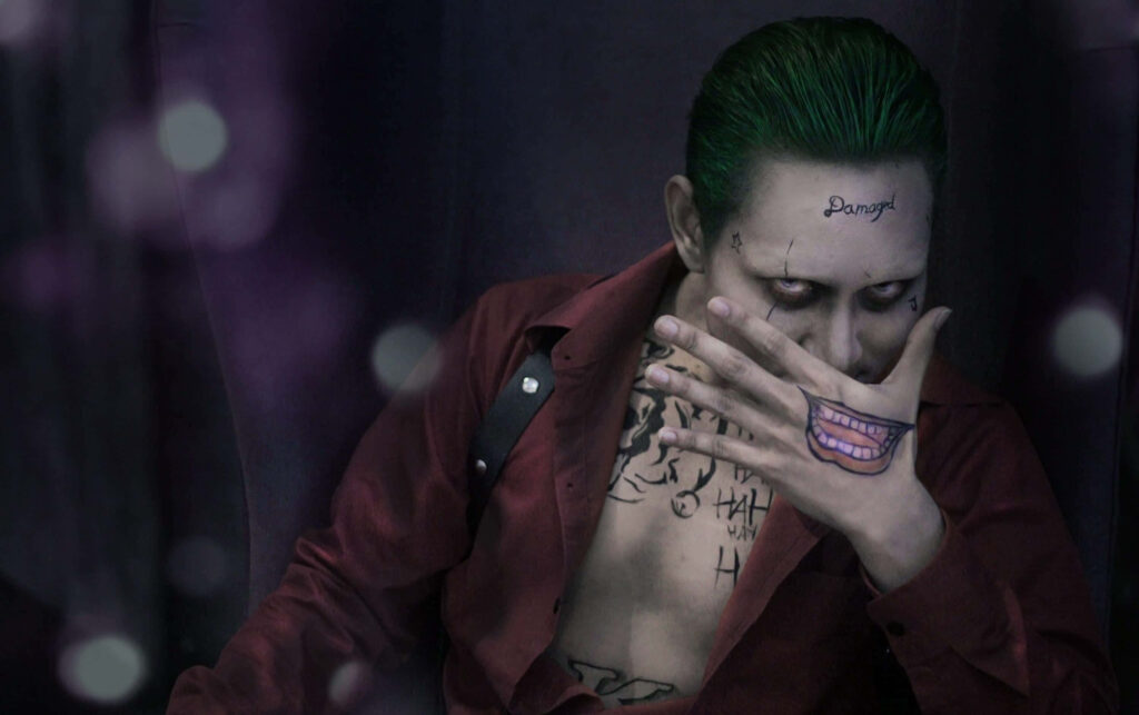 Intense Man with Green Hair & Tattoos - Striking Wallpaper Background
