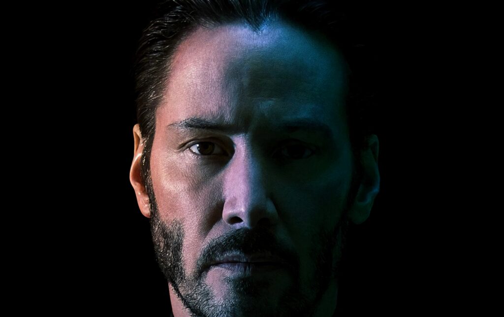 Intense Keanu Reeves Half-Face Wallpaper on Dark Background