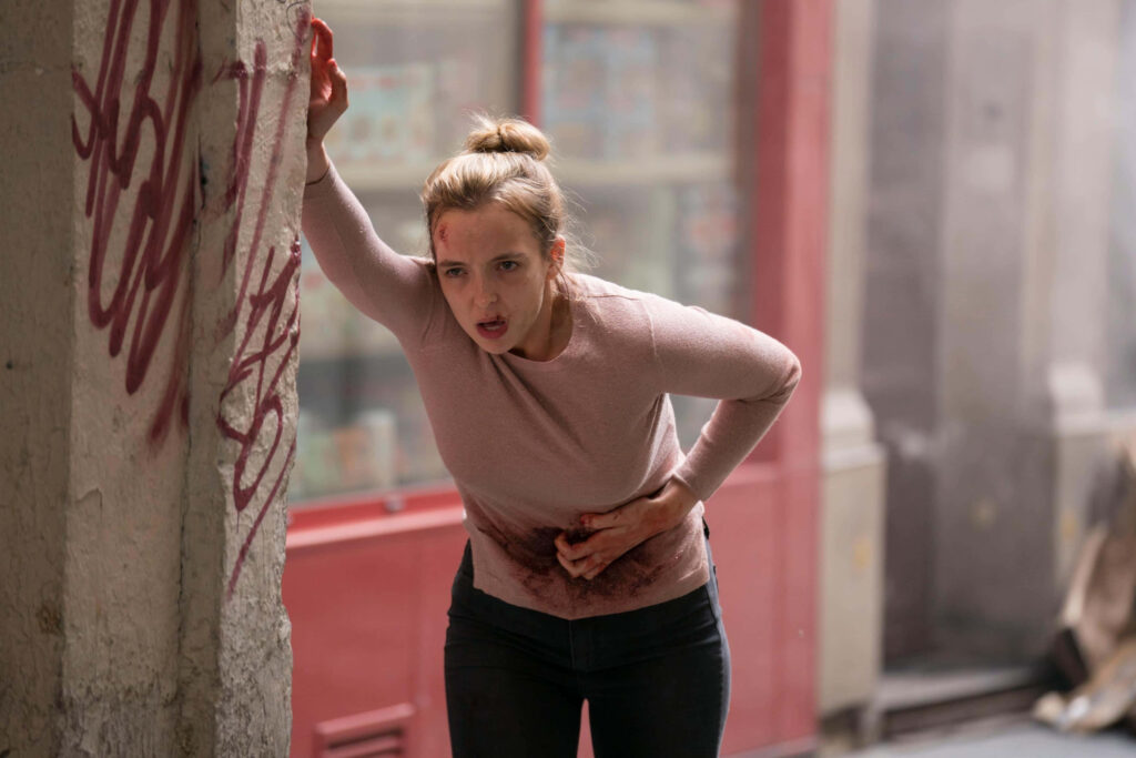 Wounded Character Wallpaper from Killing Eve: Intense Emotions & Drama