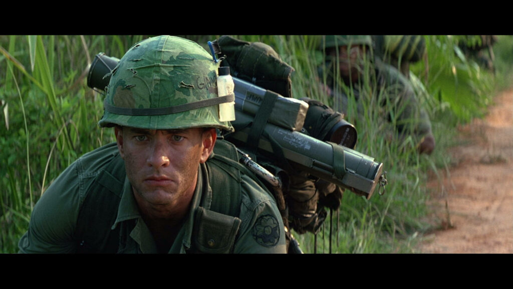 Intense Military Wallpaper: Soldier in Camouflage Amid Dense Greenery