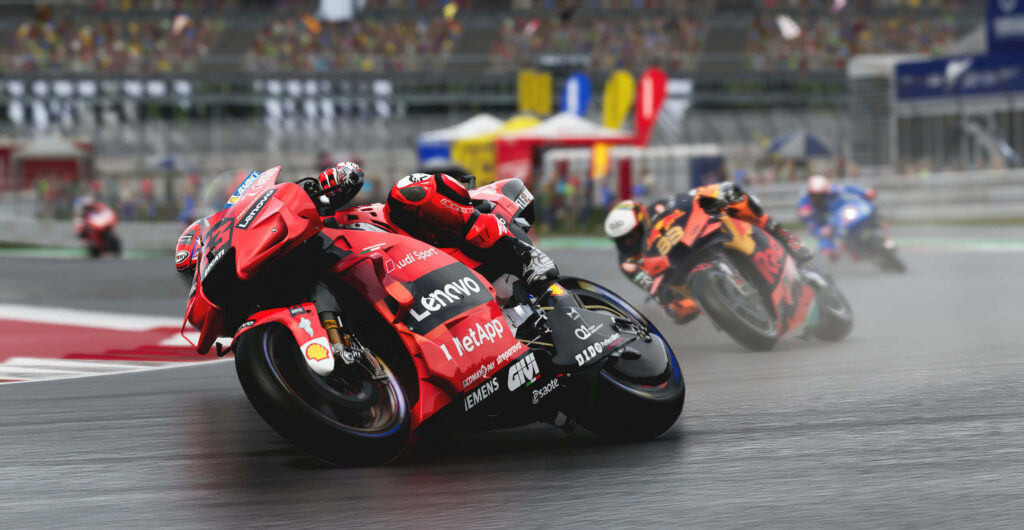 Thrilling Motorcycle Race Wallpaper: Intense Wet Track Action