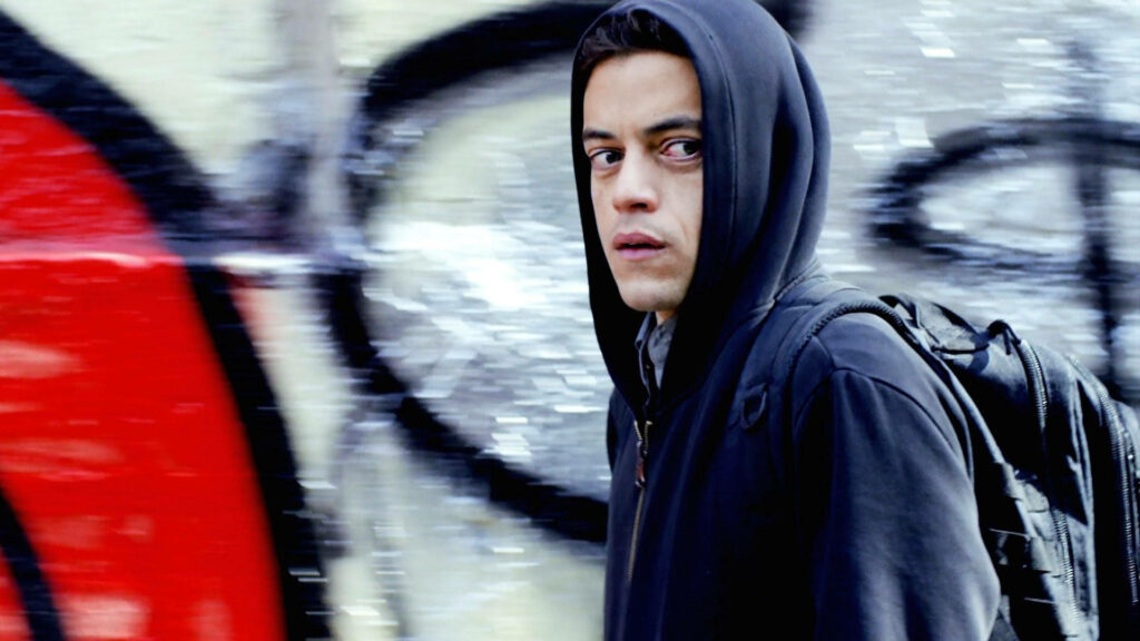 Intense Mr. Robot Character Wallpaper with Gritty Urban Backdrop