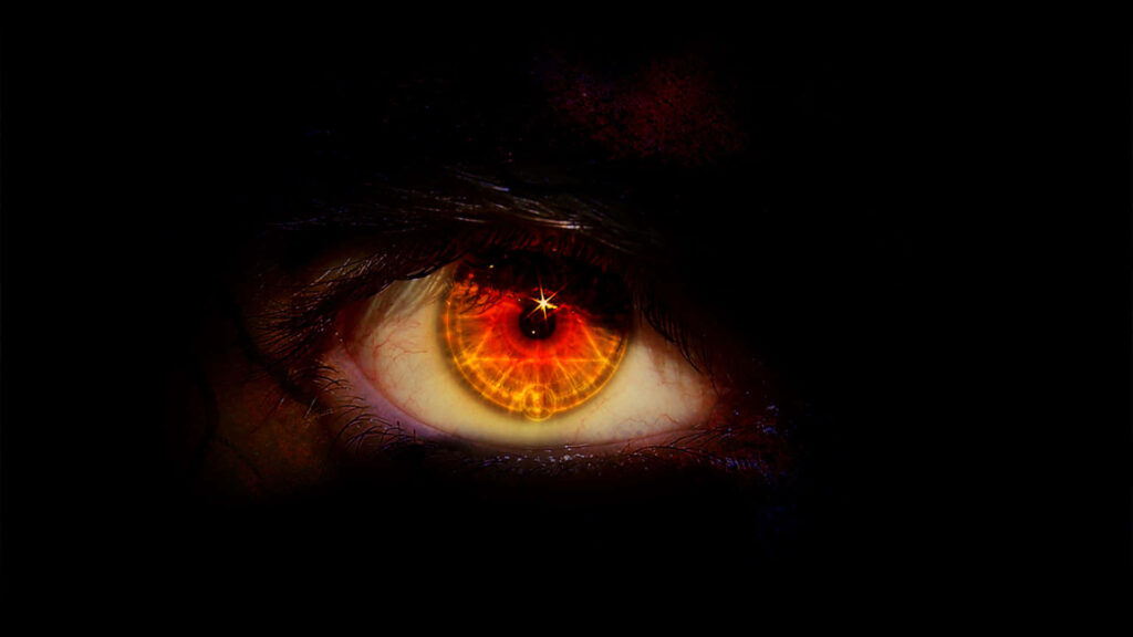 Closeup of a vivid orange eye with detailed iris against dark background intense and mysterious Wallpaper