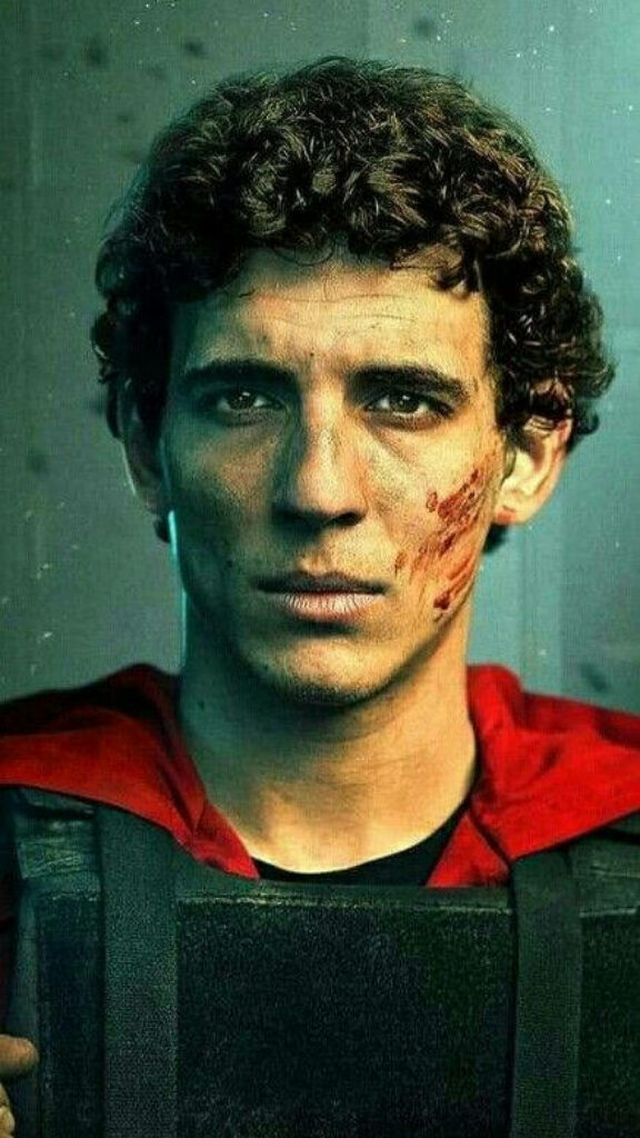 Intense Transformation: Rio from Money Heist Embodies Resilience Amidst Chaos, Sporting a Red Garb with a Blood-Streaked Countenance Wallpaper