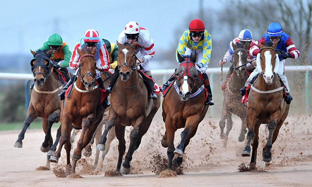 Jockeys race powerful horses on muddy track under overcast sky high action horse racing wallpaper