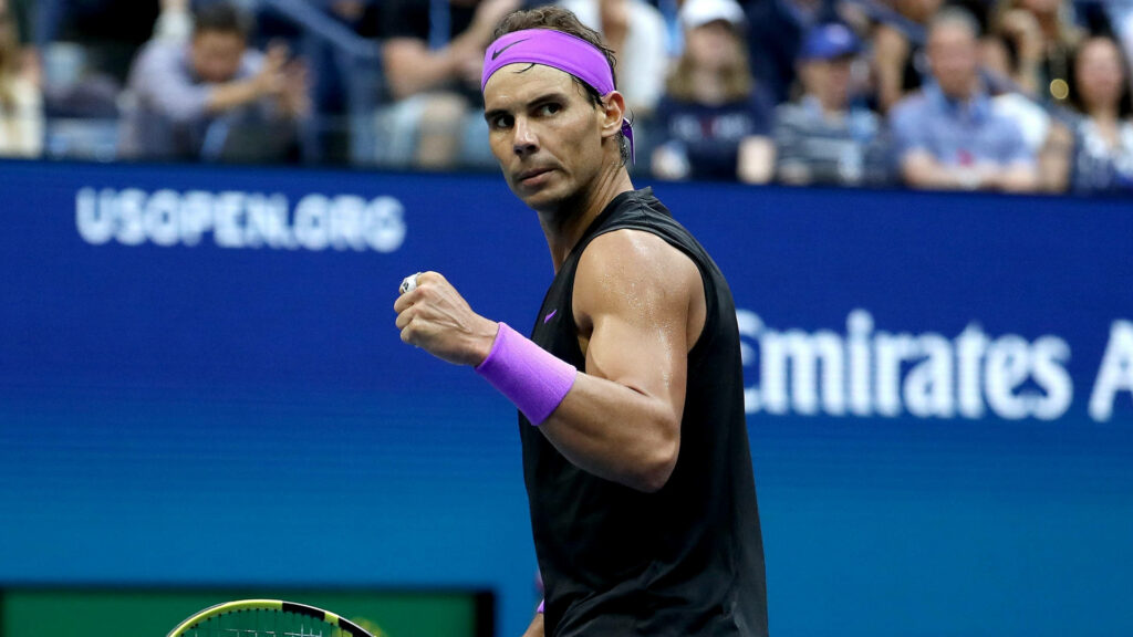 Determined Rafael Nadal in Intense Tennis Match - Wallpaper Background