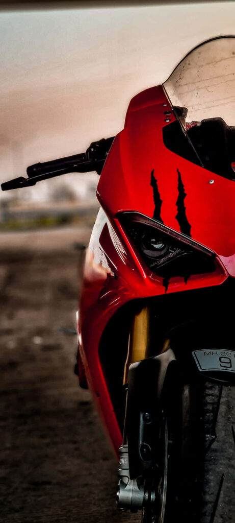 Intense Red Superbike Close-Up: Fierce Design Wallpaper Background