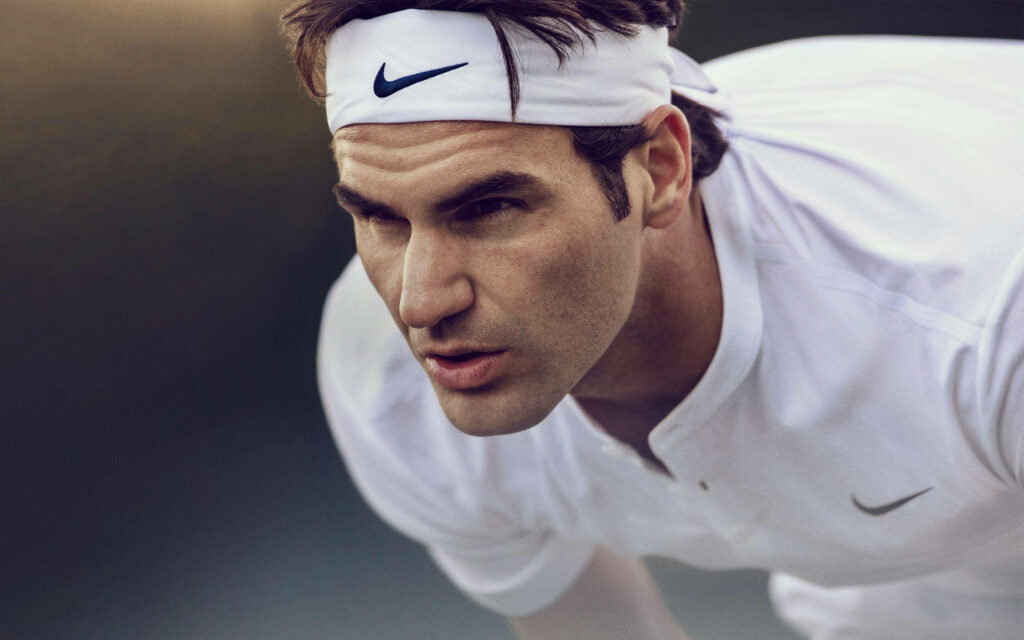 Roger Federer in Action: Intense Tennis Wallpaper with Focus and Determination