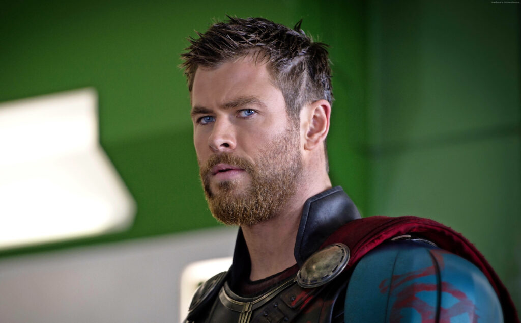 Powerful Stare: Chris Hemsworth in 4K Thor Ragnarok Wallpaper