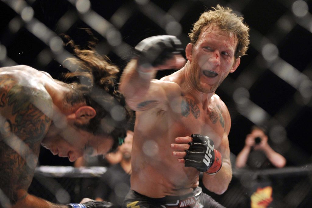 UFC fighter Gray Maynard punches Frankie Edgar in intense Octagon MMA action wallpaper