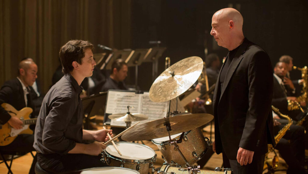 Intense Whiplash Wallpaper: Drummer vs. Instructor Scene Background