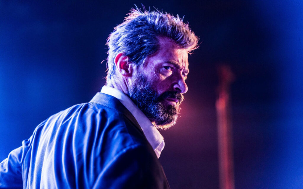 Wolverine in Suit: Intense X-Men Wallpaper Background with Dramatic Lighting