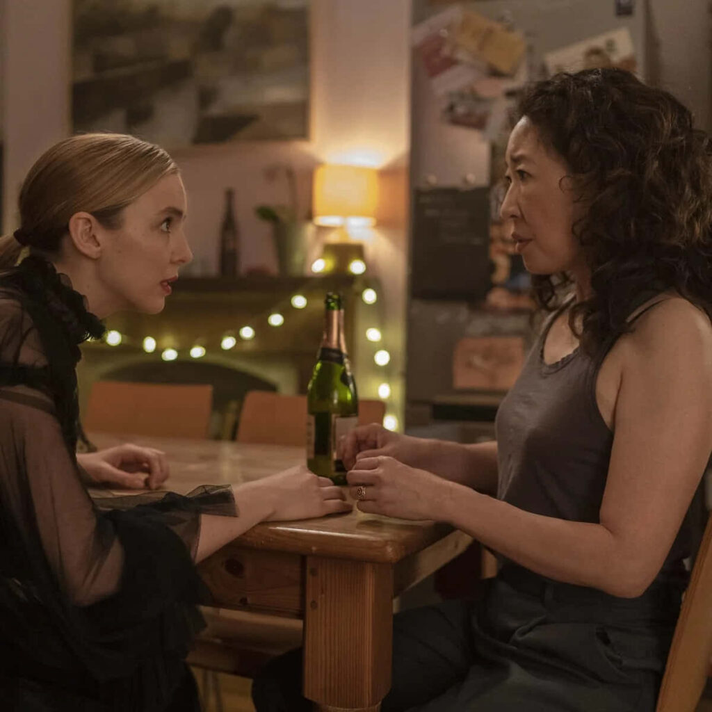 Killing Eve Tense Conversation Wallpaper in Cozy Dim Lighting