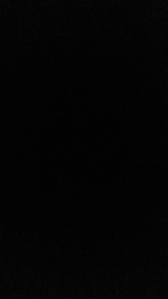 Solid black iPhone wallpaper for OLED screens minimalist deep space void background design