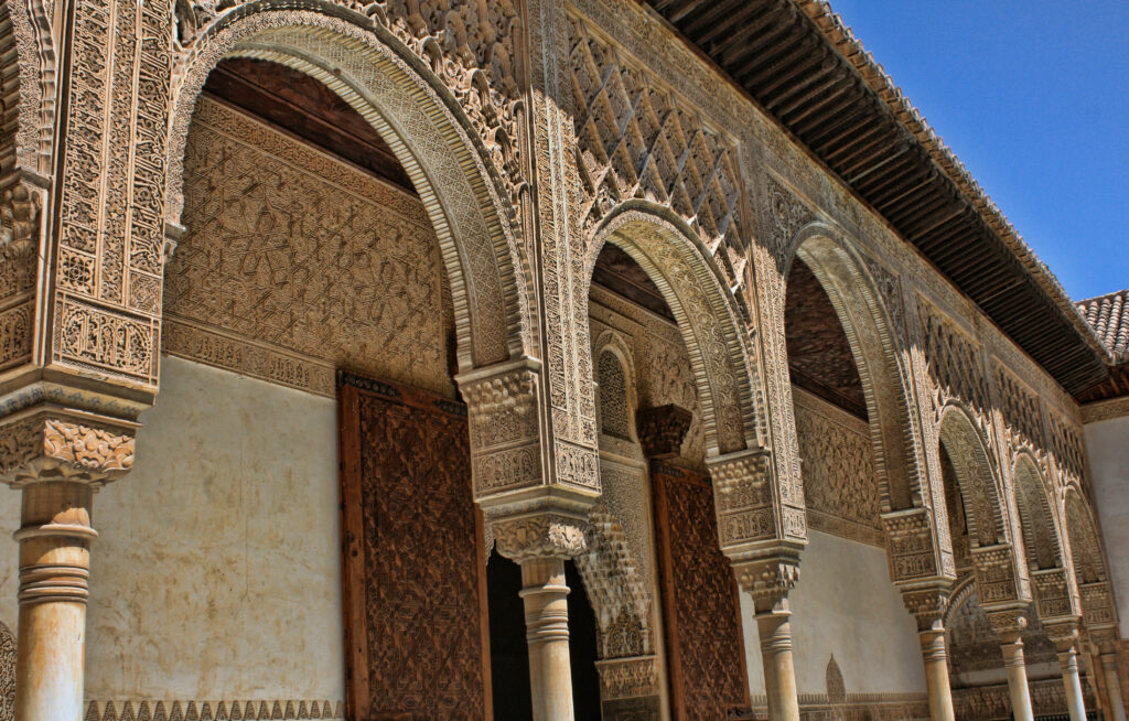 Stunning Alhambra Wallpaper: Intricate Architecture & Blue Sky Beauty