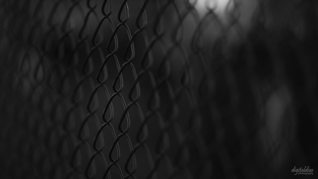 Intricate Black Wire Mesh Fence Wallpaper - Minimalistic Aesthetic