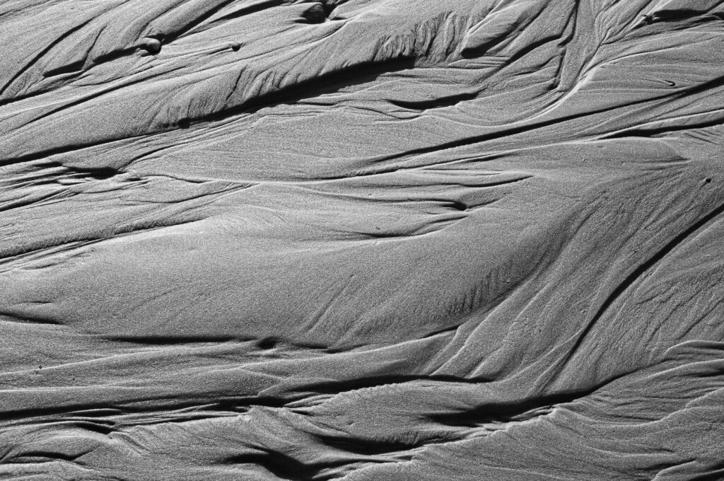 Intricate Black and White Sand Wallpaper: Textured Wave Patterns