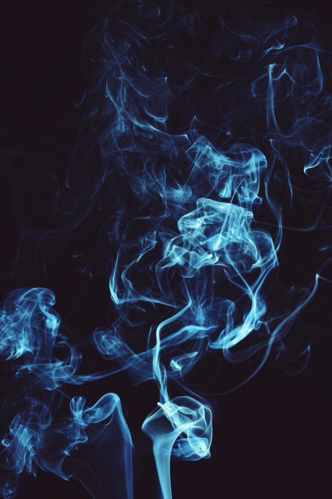 Intricate Blue Smoke Wallpaper: Ethereal Design on Dark Background