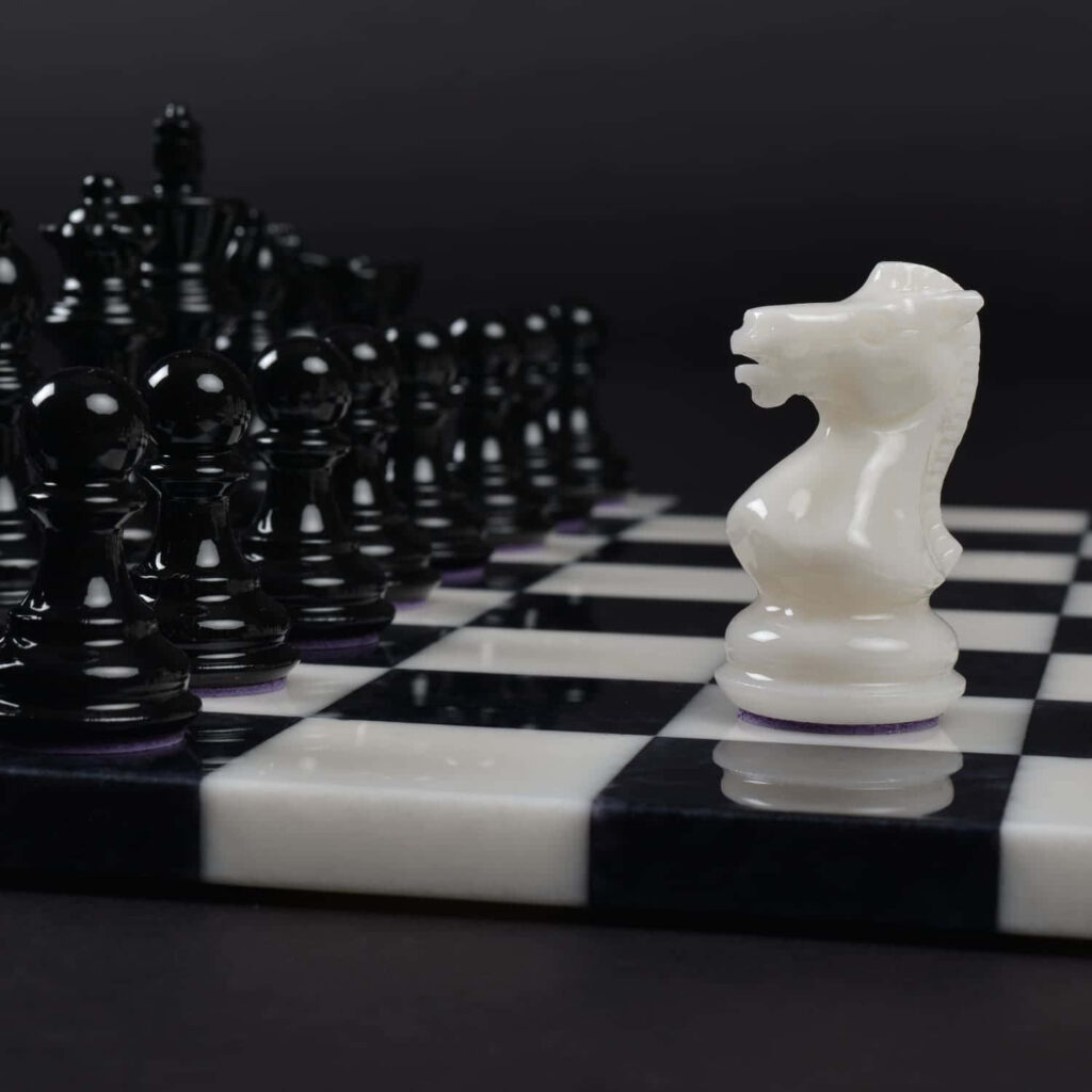 Close-Up Chess Wallpaper: Intricate Black & White Pieces in Action