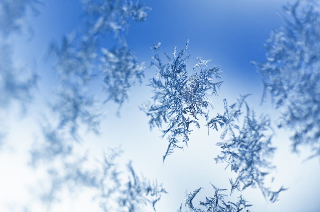 Intricate Frost Patterns Wallpaper: Vibrant Blue Snow Macro Background