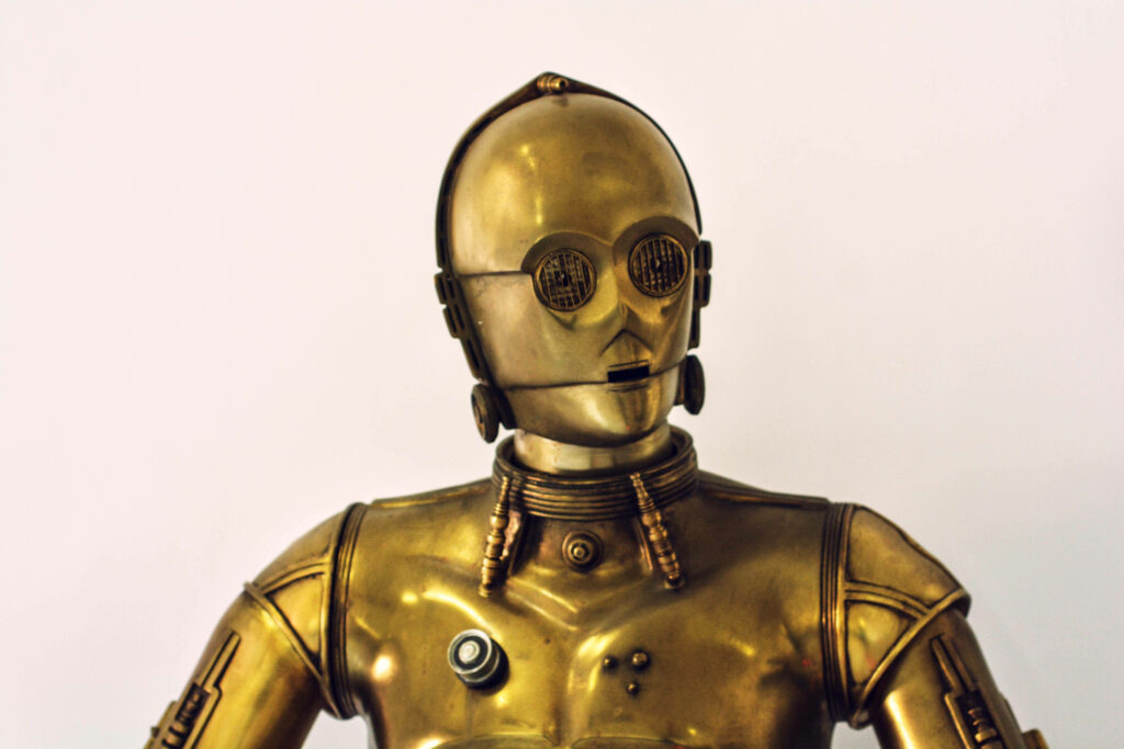 Stunning Golden Robot Wallpaper: Intricate Design on Minimal Background