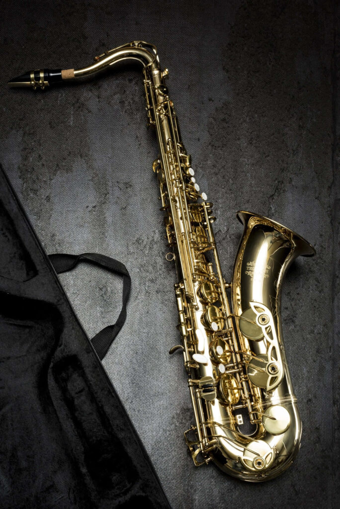 Elegant Saxophone Wallpaper: Intricate Design on Dark Background