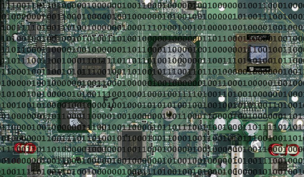 Intricate Green Motherboard Wallpaper with Binary Code Overlay
