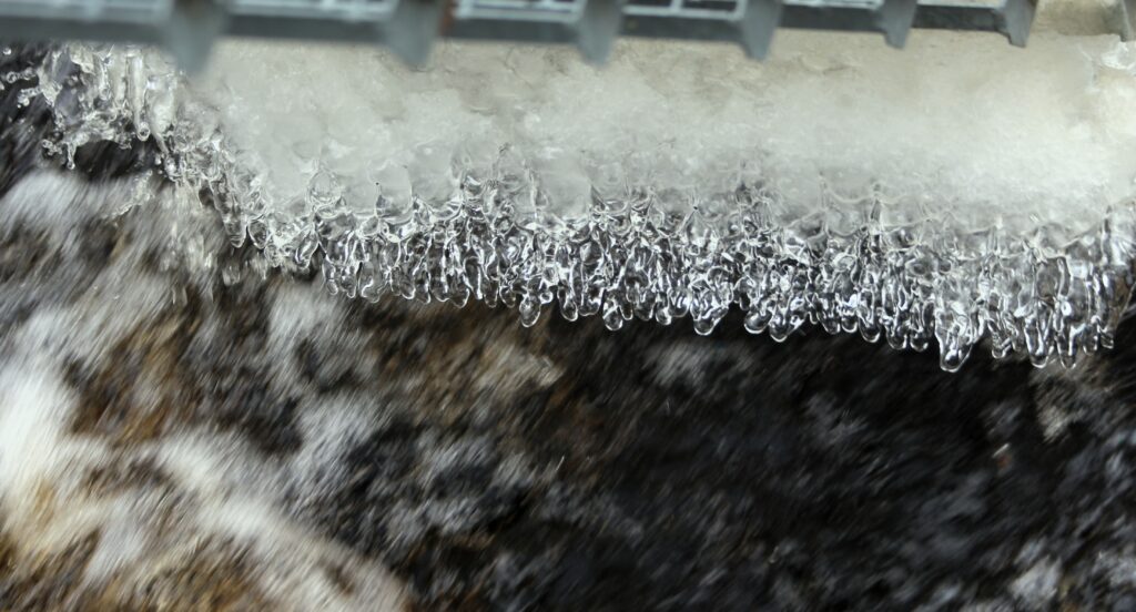 Intricate Icicles Macro Wallpaper Background with Textured Ice Details