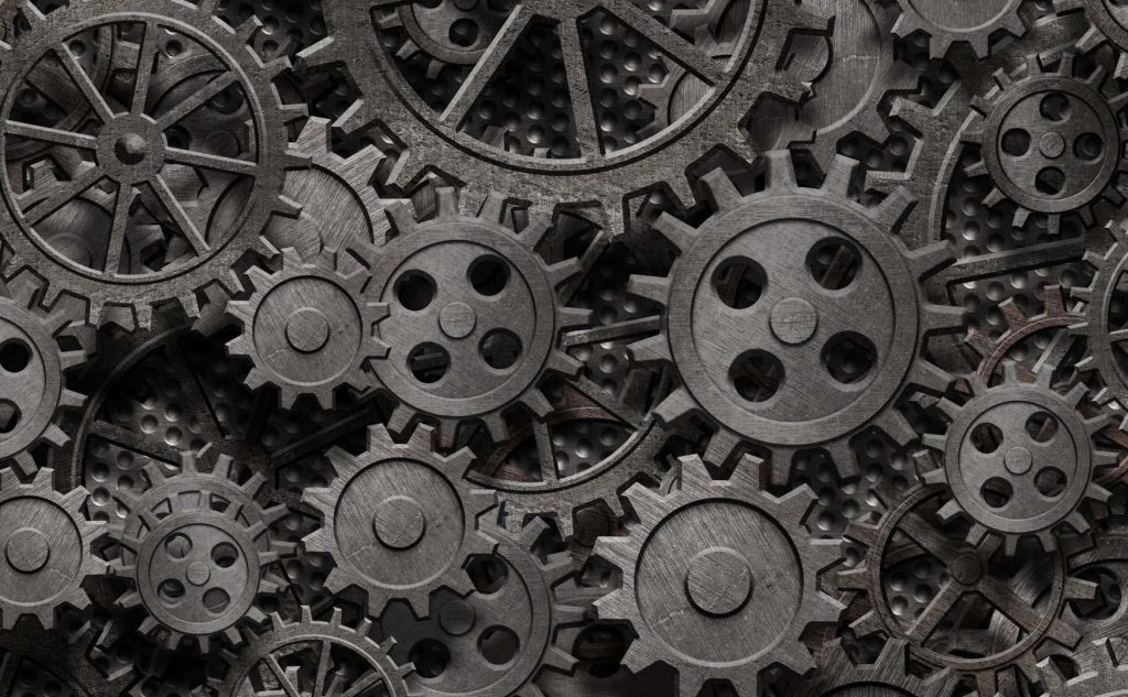Intricate metallic gears and cogs on perforated steel background industrial steampunk wallpaper