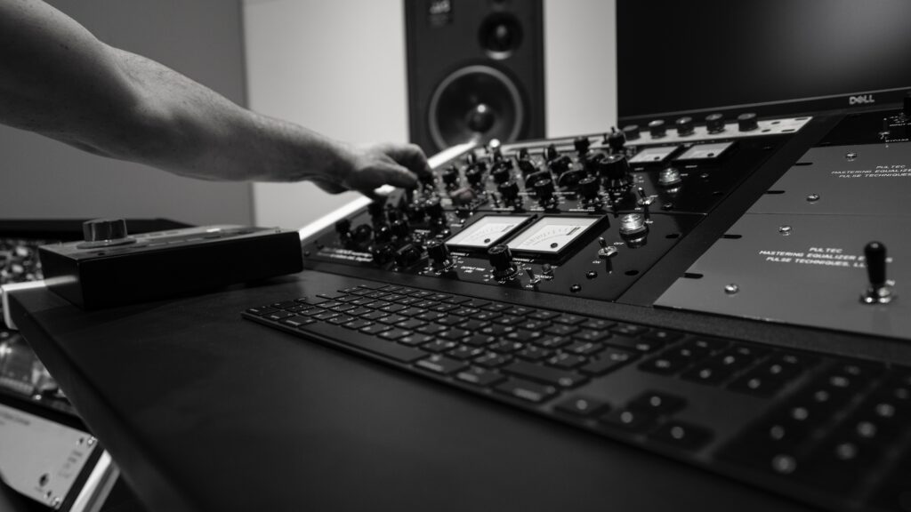 Intricate Music Studio Wallpaper: DJ Hand Adjusts Console Controls