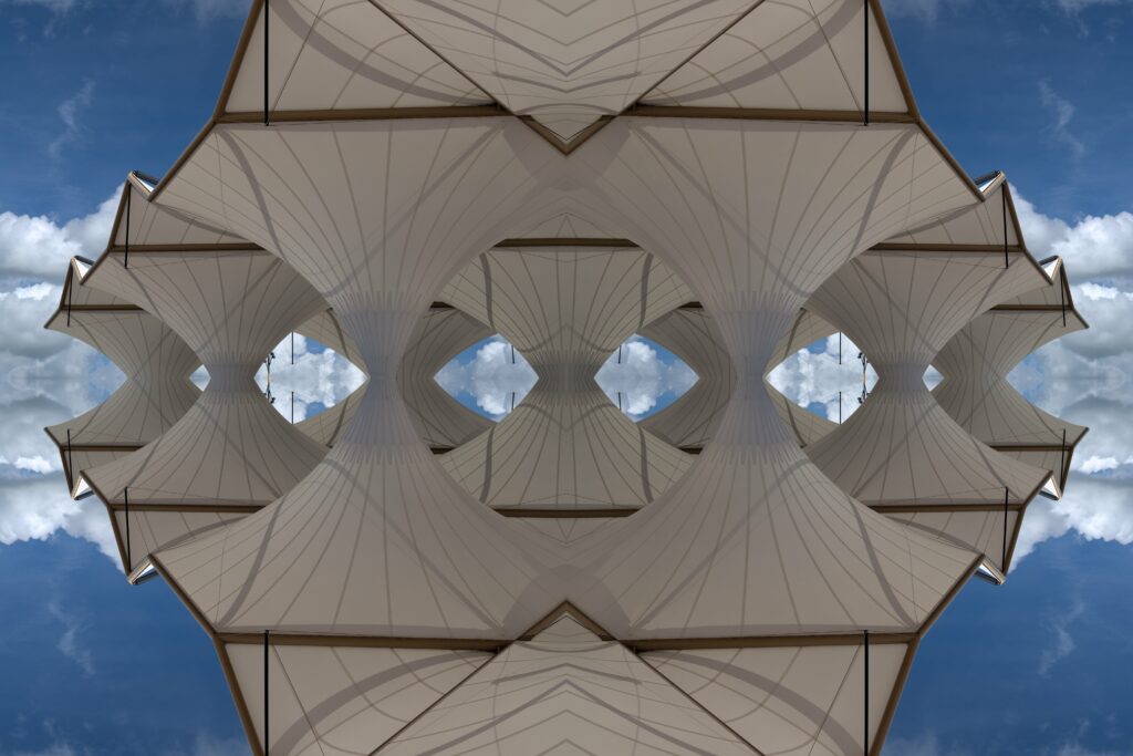 Intricate Origami Pattern Wallpaper with Blue Sky and Clouds Background