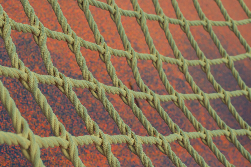 Intricate Rope Net Wallpaper on Vibrant Orange Background