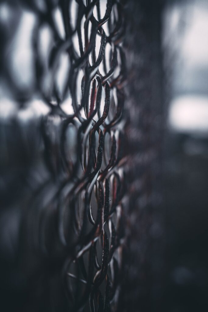 Intricate Rusty Iron Fence Close-Up: Moody Wallpaper Background