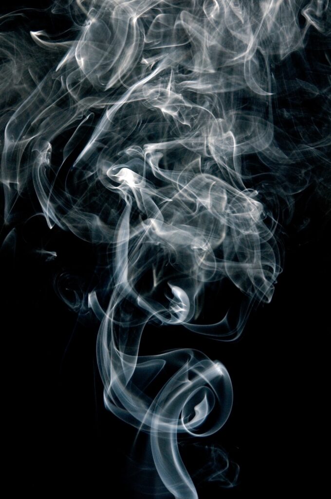 Ethereal Smoke Puff Wallpaper: Intricate Patterns on Dark Background