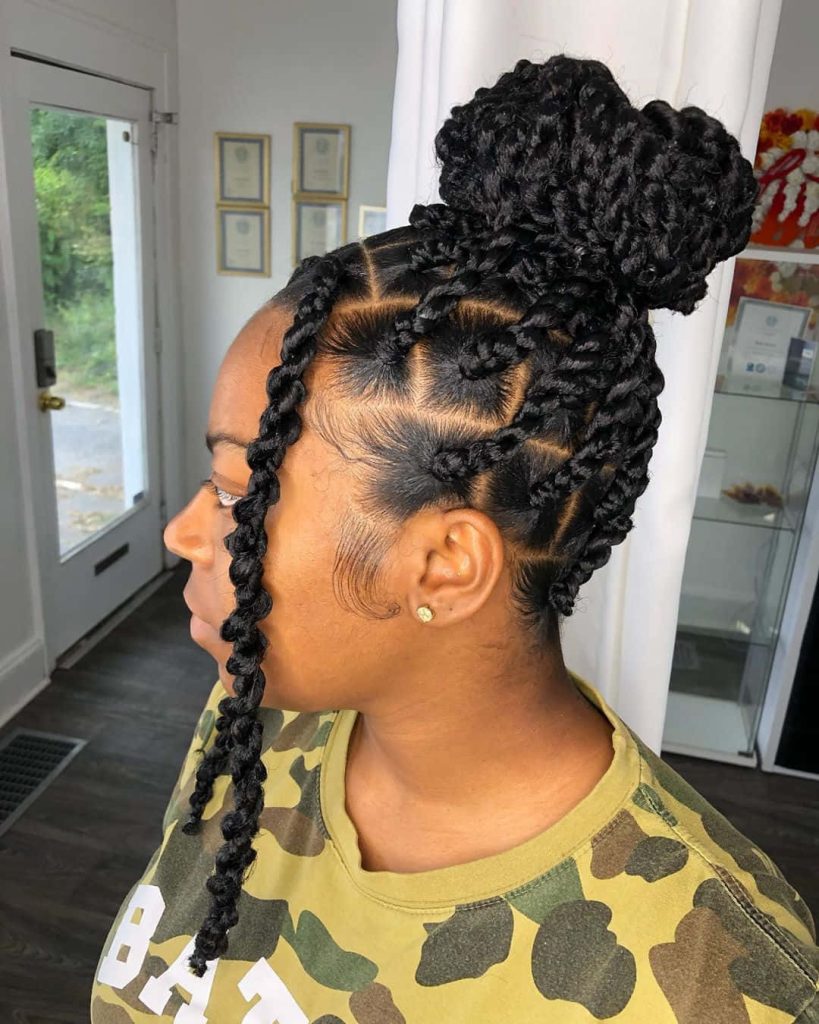 Profile of woman with detailed square-parted box twists in voluminous high bun hairstyle Wallpaper