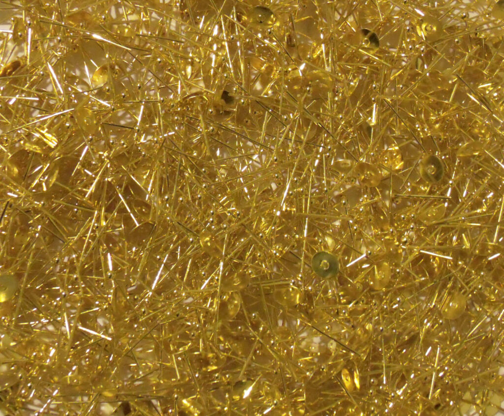Intricate Gold Pin Wallpaper: Textured Close-Up Background Design