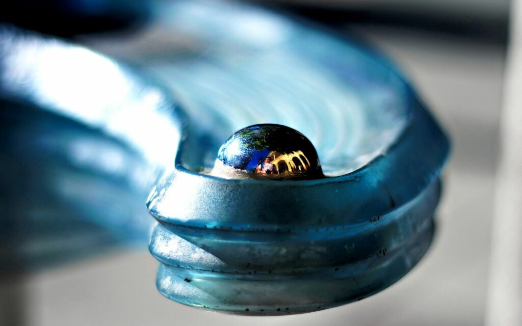 Shiny Metallic Surface with Reflective Ball: Textured Wallpaper Background
