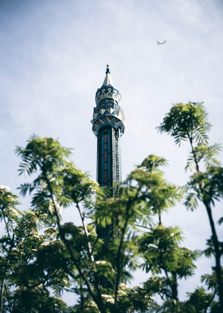 Intricate Tower Wallpaper Against Clear Blue Sky - Serene Background