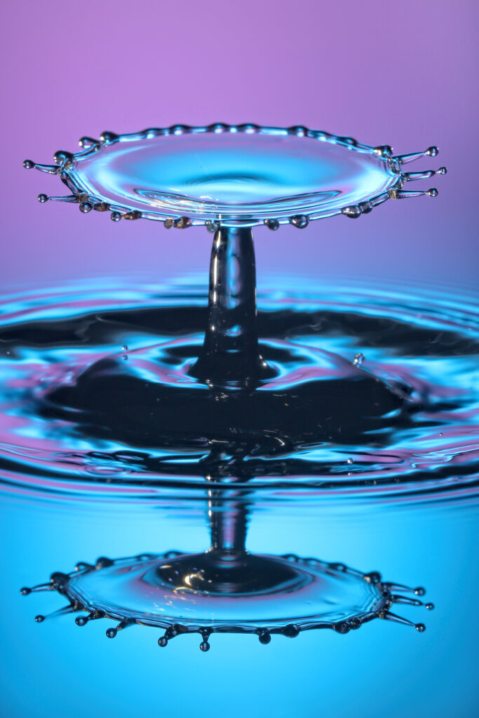 Stunning Macro Water Drop Splash with Gradient Background Wallpaper