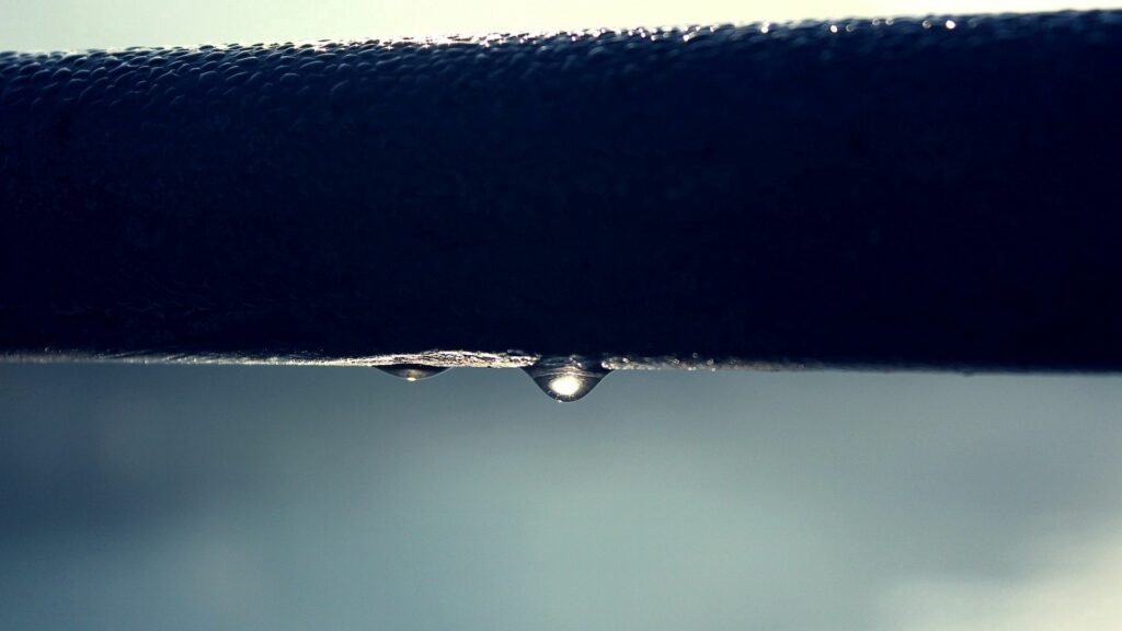 Intricate Water Droplet Wallpaper Background: Liquid Tension & Texture