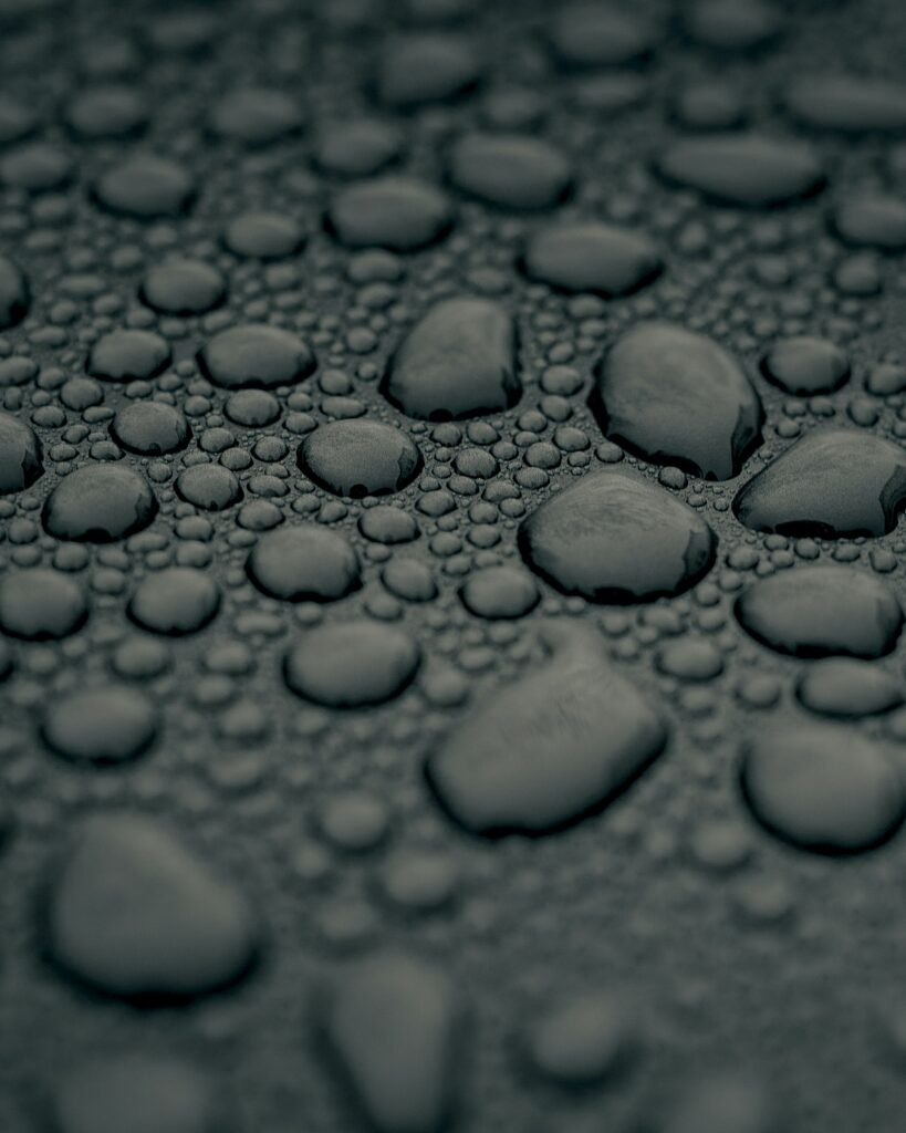 Intricate Water Drops on Textured Gray Surface - Wallpaper Background