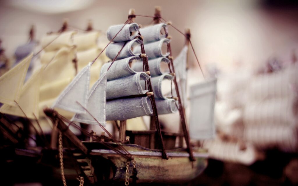 Intricate Wooden Toy Ships: Charming Maritime Wallpaper Background