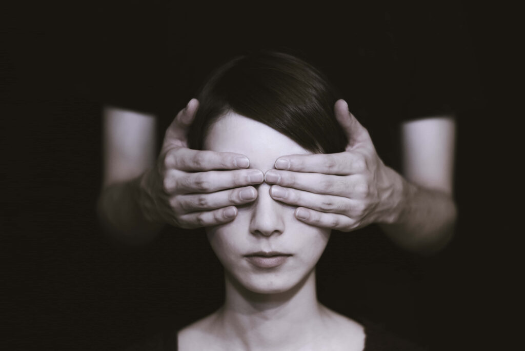 Minimalist Portrait: Enigmatic Woman with Covered Eyes - Dark Background Wallpaper