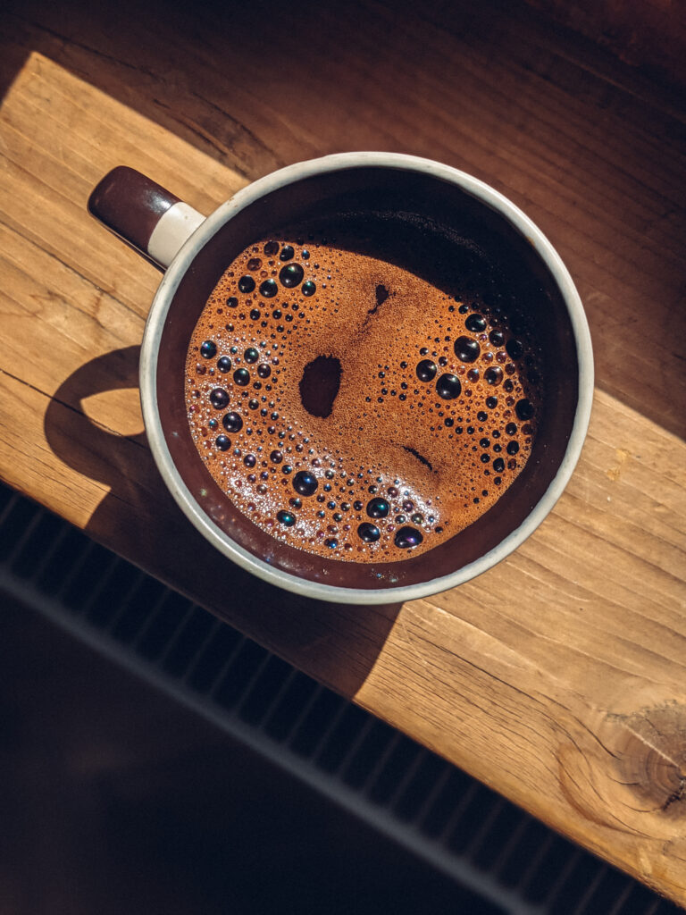 Inviting Strong Coffee Wallpaper: Rich Frothy Delight on Wood