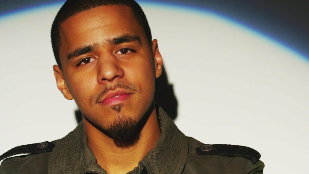 J Cole: Vibrant in Green – HD Music Wallpaper on a White Background