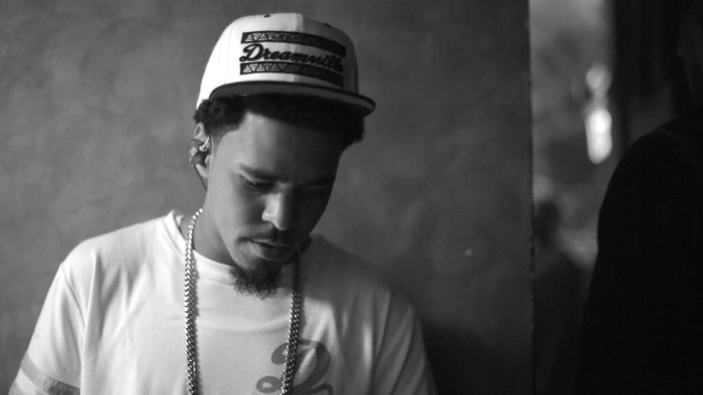 Soulful Serenade: J Cole's Iconic Musical Persona in High-Definition Portrait Wallpaper