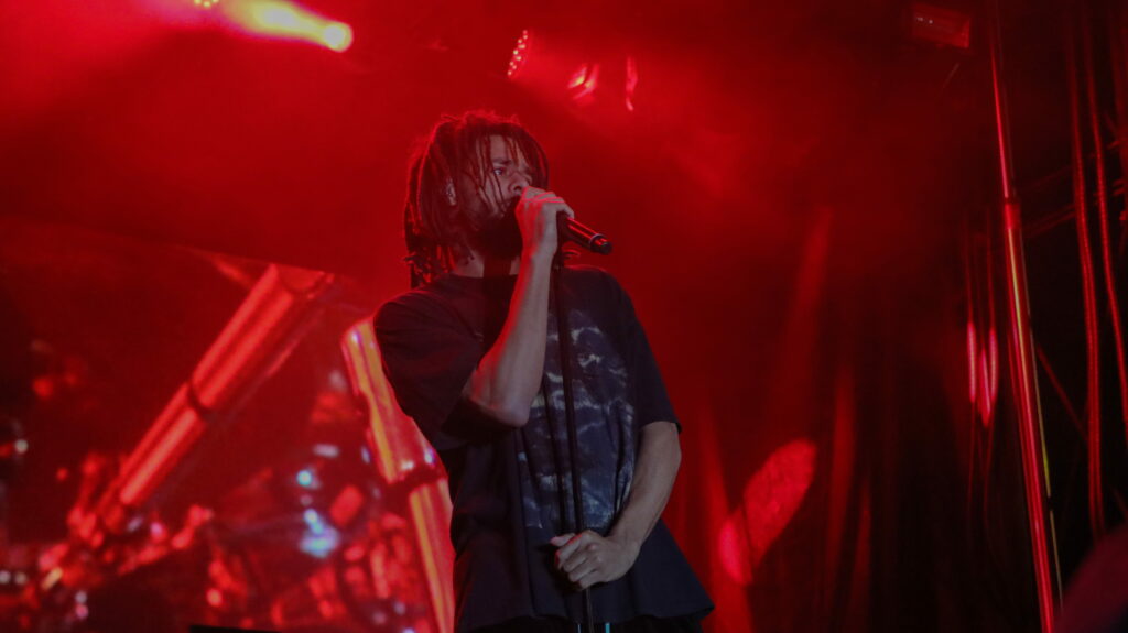 J. Cole's Energetic Houston Concert: Vibrant Red Light Experience in Stunning HD Wallpaper