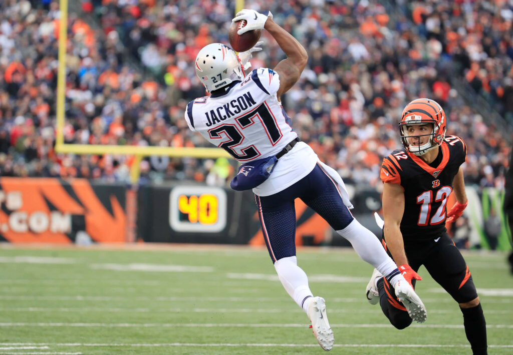 JC Jackson's Stunning Interception: Dynamic American Football Wallpaper