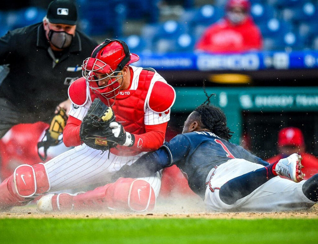 JT Realmuto Blocks the Plate: Intense Baseball Action Wallpaper