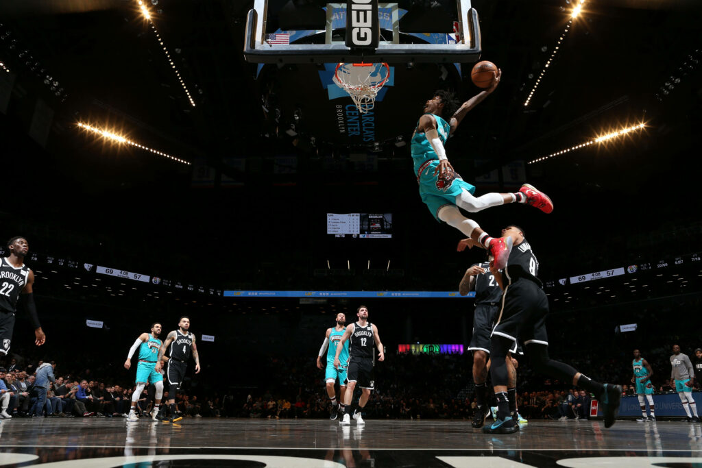 Ja Morant powerful dunk over Brooklyn Nets defenders NBA game vibrant court action wallpaper